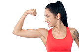 Female trainer showing her biceps