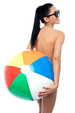 Sensual nude woman holding ball