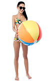 Bikini woman holding colorful ball