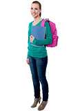 Young college girl posing with backpack