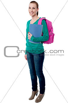 Young college girl posing with backpack