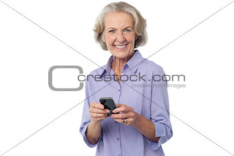 Aged woman texting on her mobile phone