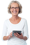 Aged woman with touch pad device