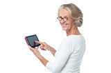 Aged lady operating touch pad device