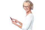 Old lady using tablet pc device
