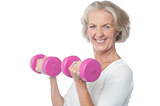 Joyous fit woman lifting dumbbells