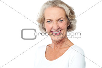 Happy smiling aged lady facing camera