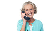 Senior lady holding phone receiver