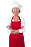 Cheerful confident aged female chef