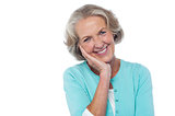 Shy and polite senior smiling woman