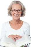 Smiling senior woman reading a book