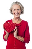 Aged woman holding a red valentine gift box