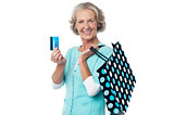 Aged woman displaying her cash card