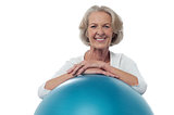 Senior woman posing with exercise ball