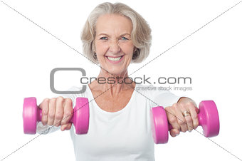 Happy aged woman exercising
