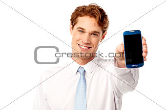 Salesman displaying newly launched mobile