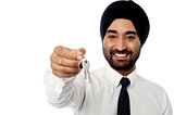 Smiling corporate guy holding a key