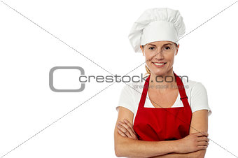 Female chef standing with her arms crossed