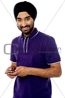 Cool young man using mobile phone