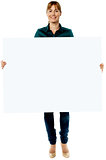 Attractive woman holding blank ad board