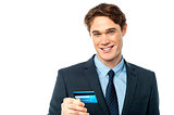 Cheerful businessman holding credit card
