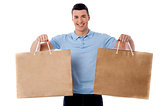 Young man holding shopping bags
