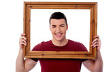 Man holding wooden picture frame