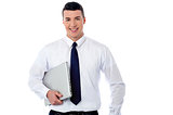 Confident corporate man holding laptop