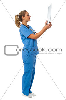 Female doctor reviewing patient's x-ray report