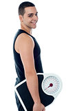 Fitness man with weighing scale