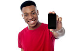 Young guy displaying brand new cellphone