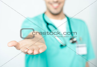 Doctor showing his palm to camera
