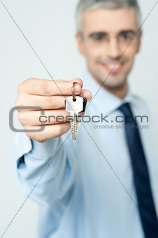 Mature realtor offering house key