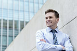 Smiling businessman standing against wall
