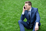 Businessman using mobile phone in park