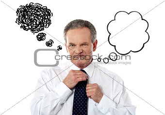 Serious businessman adjusting his tie