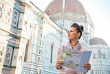 Young woman with map in front of cattedrale di santa maria del f