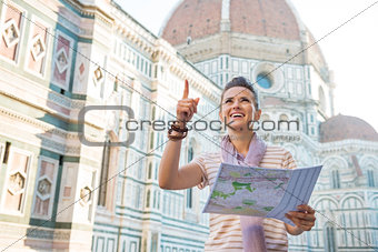 Young woman with map in front of cattedrale di santa maria del f