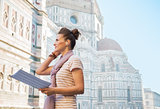 Young woman with map and audio guide in front of cattedrale di s