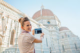 Happy young woman taking photo with tablet pc of cattedrale di s