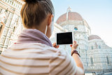 Young woman taking photo with tablet pc of cattedrale di santa m