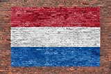 Flag of Netherlands painted over brick wall