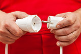 Male hands plugging or unplugging electrical wires