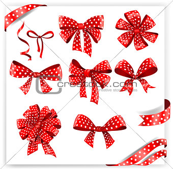 Set of red polka dot gift bows with ribbons.
