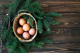 Easter eggs in the basket on rustic wooden background