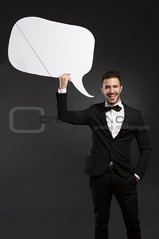 Latino young man holding a speach balloon