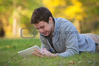 Happy Teen Writing on Grass