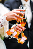 Hands of bride and groom with glasses of champagne 