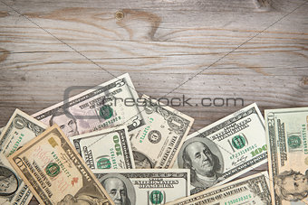 Dollars on wooden background, vintage tone.