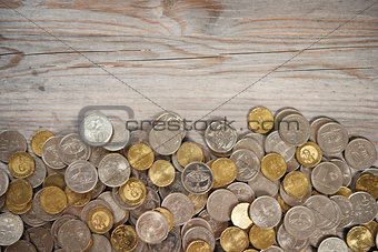 Top view coins on old wooden desk